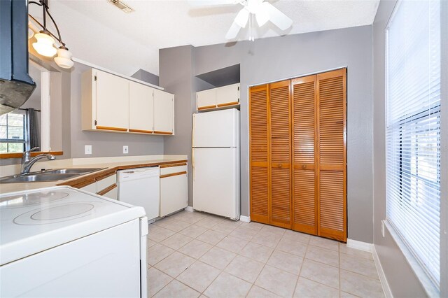 3107 Mapleshade St, Deltona, FL 32738 - kitchen featuring white appliances, a sink, lofted ceiling, a ceiling fan, and white cabinets