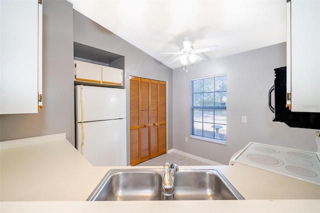 3107 Mapleshade St, Deltona, FL 32738 - kitchen with freestanding refrigerator, light countertops, ceiling fan, white cabinets, and black microwave
