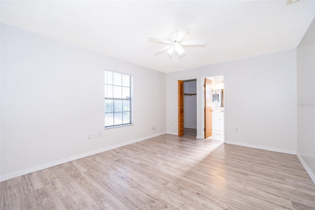 3107 Mapleshade St, Deltona, FL 32738 - unfurnished bedroom featuring light wood finished floors, baseboards, ceiling fan, ensuite bathroom, and a closet