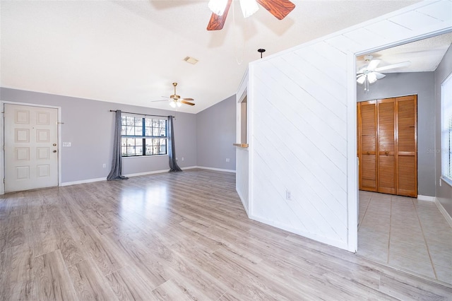 3107 Mapleshade St, Deltona, FL 32738 - unfurnished living room featuring ceiling fan, vaulted ceiling, baseboards, and light wood-type flooring