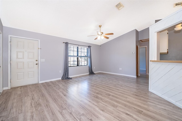 3107 Mapleshade St, Deltona, FL 32738 - unfurnished living room featuring a ceiling fan, light wood-style floors, baseboards, and vaulted ceiling