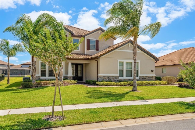 163 Rosa Bella Vw, Debary, FL 32713 - mediterranean / spanish house featuring a tiled roof, french doors, a front lawn, stone siding, and stucco siding