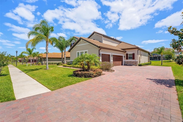 163 Rosa Bella Vw, Debary, FL 32713 - view of front of home with a tile roof, a garage, stucco siding, a front yard, and decorative driveway