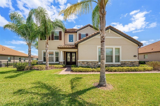 163 Rosa Bella Vw, Debary, FL 32713 - mediterranean / spanish home featuring a tiled roof, fence, french doors, and stone siding