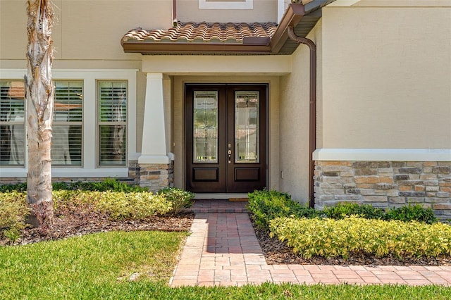 163 Rosa Bella Vw, Debary, FL 32713 - property entrance with french doors, stone siding, and stucco siding