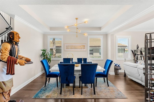 163 Rosa Bella Vw, Debary, FL 32713 - dining room with a notable chandelier, a tray ceiling, dark wood-style floors, and a wealth of natural light