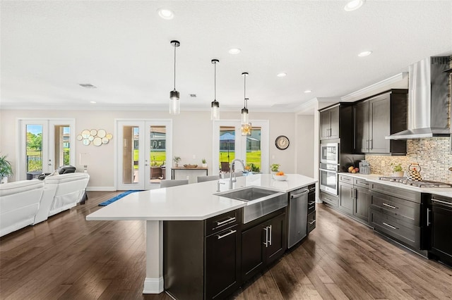 163 Rosa Bella Vw, Debary, FL 32713 - kitchen with wall chimney range hood, a sink, light countertops, french doors, and stainless steel appliances