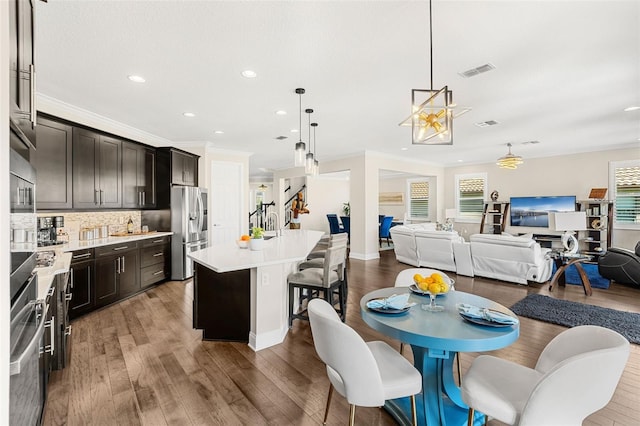 163 Rosa Bella Vw, Debary, FL 32713 - dining area with recessed lighting, visible vents, ornamental molding, and wood finished floors