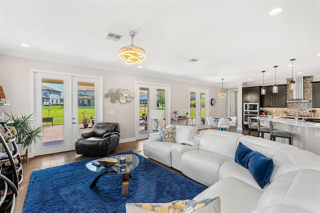163 Rosa Bella Vw, Debary, FL 32713 - living area with crown molding, french doors, recessed lighting, wood finished floors, and visible vents