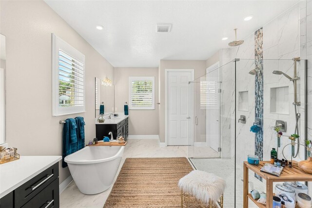 163 Rosa Bella Vw, Debary, FL 32713 - bathroom featuring a freestanding bath, a stall shower, vanity, baseboards, and marble finish floor