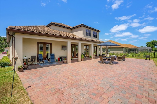 163 Rosa Bella Vw, Debary, FL 32713 - rear view of house with french doors, fence, stucco siding, and a patio area