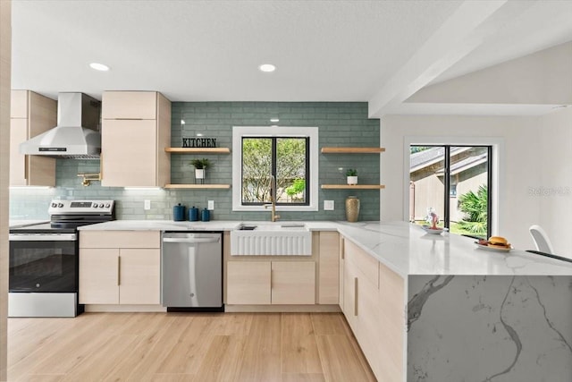 kitchen with wall chimney range hood, open shelves, stainless steel appliances, and backsplash