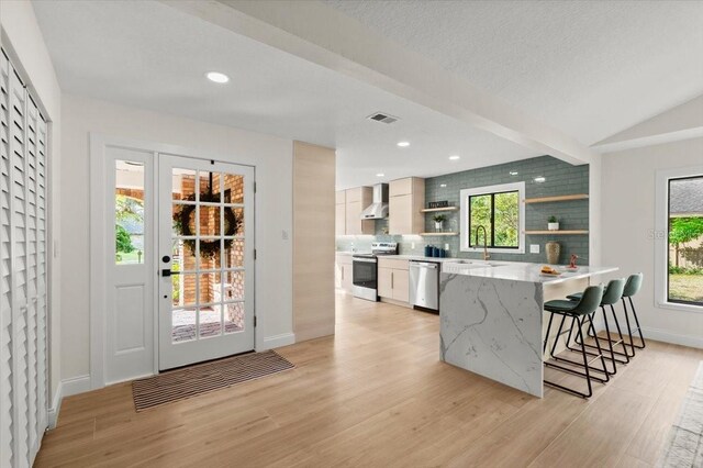 kitchen with wall chimney range hood, visible vents, electric range oven, open shelves, and stainless steel dishwasher