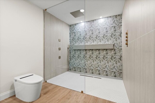 full bath with recessed lighting, a walk in shower, wood finished floors, and toilet
