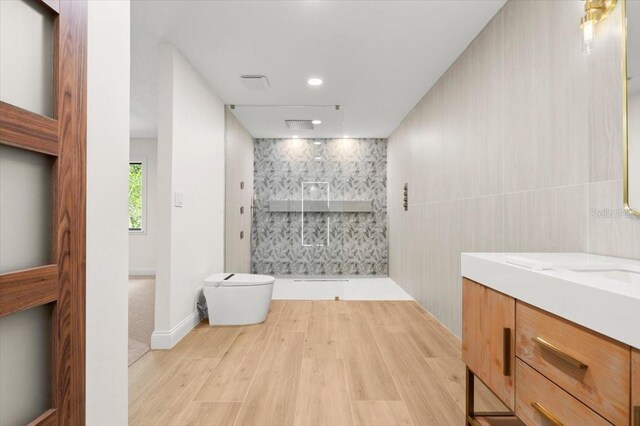 full bath with vanity, wood finished floors, toilet, walk in shower, and recessed lighting