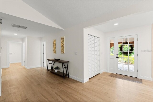 entrance foyer with baseboards, light wood-type flooring, and visible vents