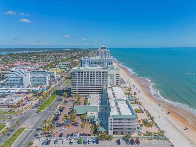 birds eye view of property with a view of city, a water view, and a beach view
