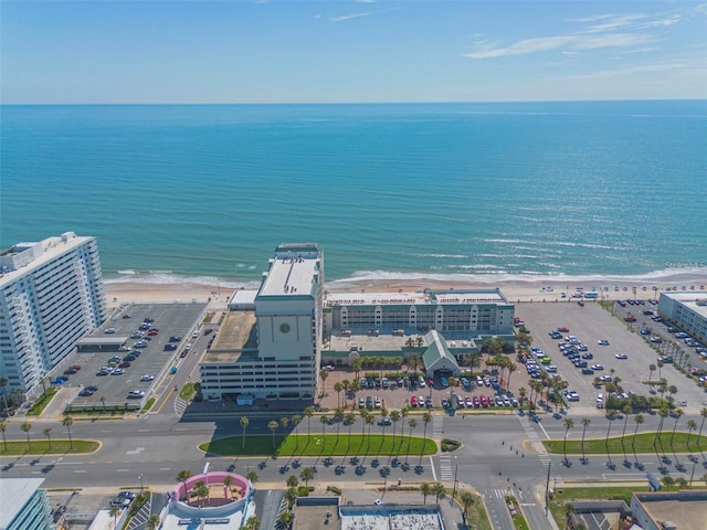 drone / aerial view featuring a beach view and a water view