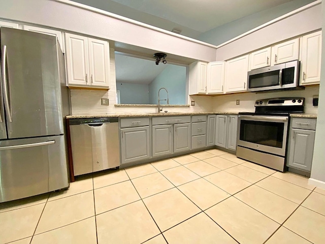 206 Westmoor Bnd, Orlando, FL 32835 - kitchen featuring stainless steel appliances, gray cabinets, vaulted ceiling, and a sink