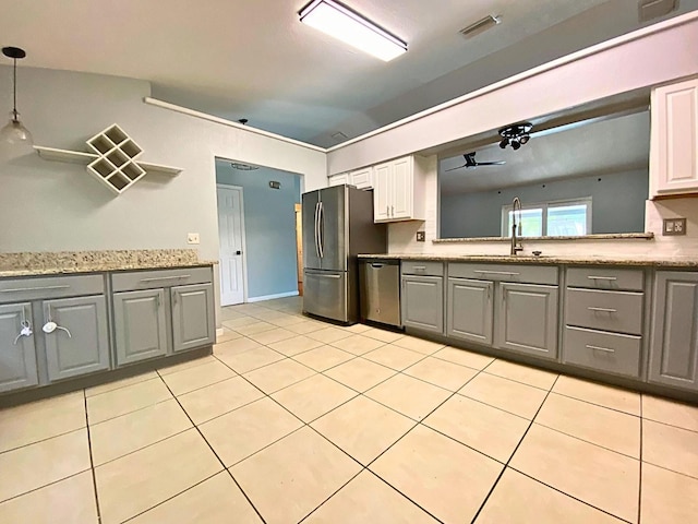 206 Westmoor Bnd, Orlando, FL 32835 - kitchen featuring light tile patterned flooring, gray cabinets, appliances with stainless steel finishes, and a sink
