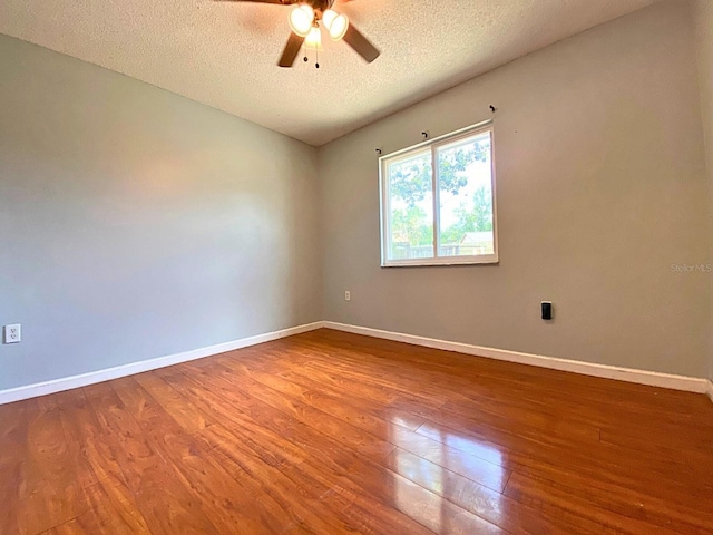 206 Westmoor Bnd, Orlando, FL 32835 - spare room with baseboards, a textured ceiling, ceiling fan, and wood finished floors