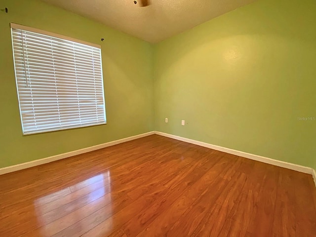 206 Westmoor Bnd, Orlando, FL 32835 - unfurnished room featuring baseboards, a textured ceiling, and wood finished floors