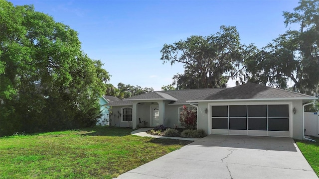1715 Queen Palm Dr, Edgewater, FL 32132 - ranch-style home with concrete driveway, stucco siding, a garage, and a front lawn