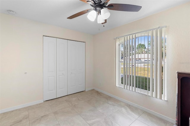 1715 Queen Palm Dr, Edgewater, FL 32132 - unfurnished bedroom featuring baseboards, a closet, and a ceiling fan