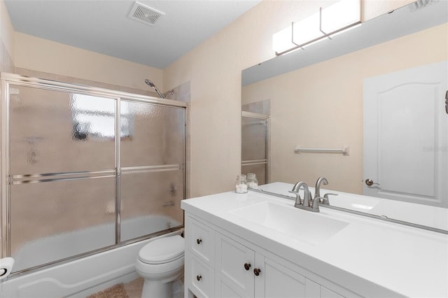 1715 Queen Palm Dr, Edgewater, FL 32132 - bathroom with combined bath / shower with glass door, vanity, and toilet