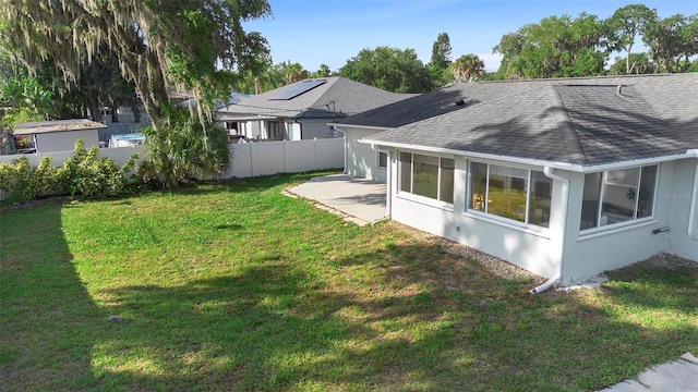 1715 Queen Palm Dr, Edgewater, FL 32132 - back of house with roof with shingles, a patio area, a sunroom, and stucco siding