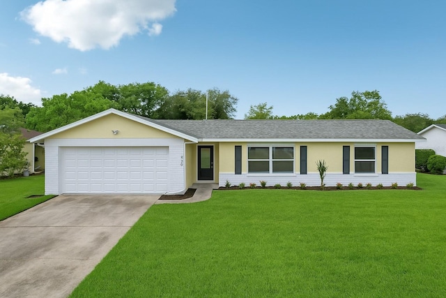 ranch-style home featuring a front yard, concrete driveway, a shingled roof, and a garage