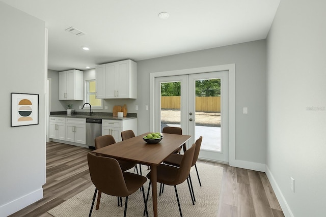 dining room with a wealth of natural light, visible vents, french doors, and baseboards