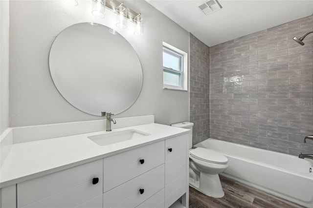 full bathroom with toilet, visible vents, vanity, bathtub / shower combination, and wood finished floors