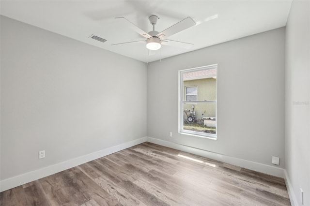 unfurnished room with ceiling fan, baseboards, and wood finished floors