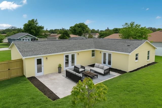 back of property featuring outdoor lounge area, a yard, roof with shingles, and french doors
