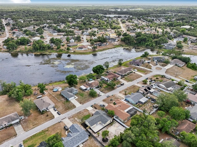 bird's eye view featuring a water view and a residential view