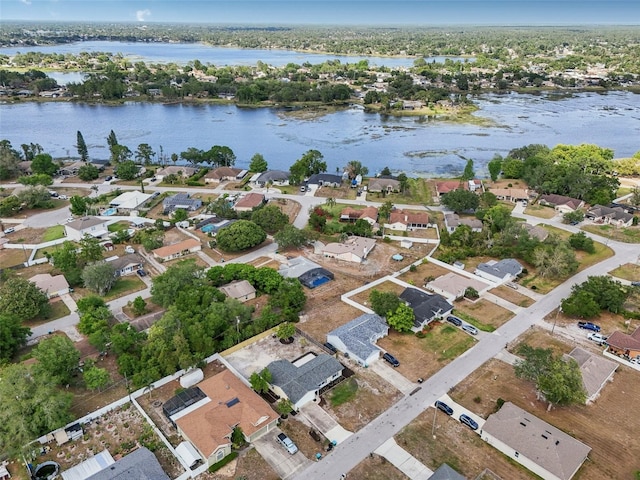 drone / aerial view with a water view and a residential view