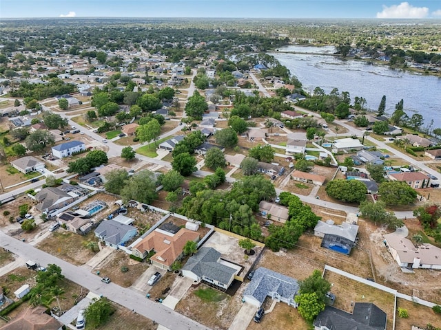 drone / aerial view with a water view and a residential view