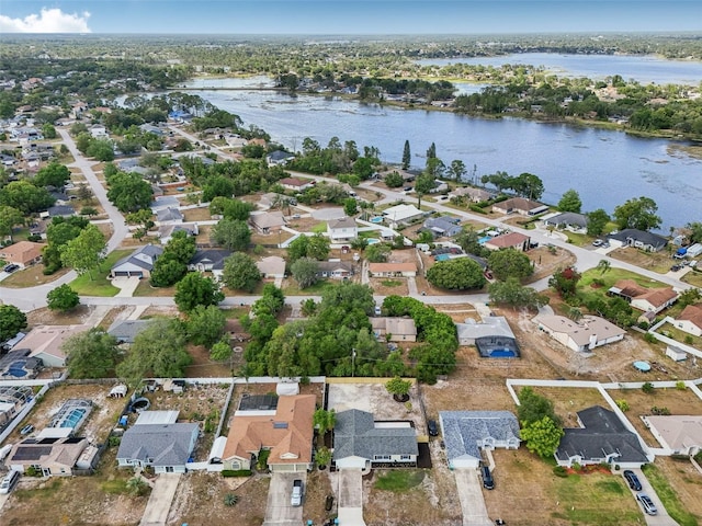 drone / aerial view with a water view and a residential view