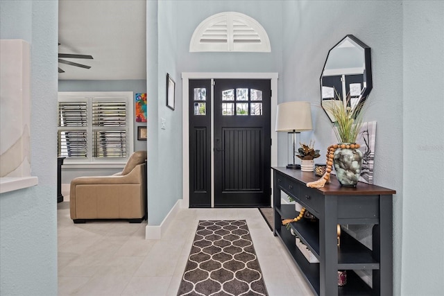 1446 Stone Trl, Enterprise, FL 32725 - tiled foyer entrance with baseboards and ceiling fan
