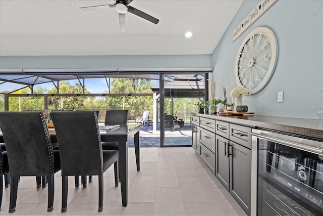1446 Stone Trl, Enterprise, FL 32725 - dining space with a ceiling fan, a textured ceiling, light tile patterned floors, and beverage cooler