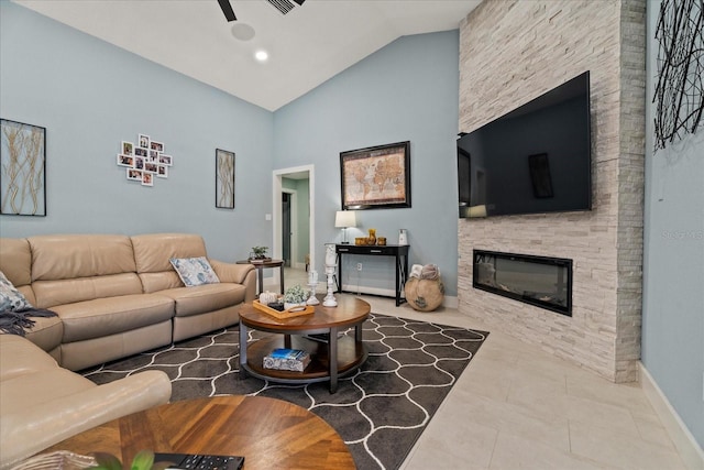 1446 Stone Trl, Enterprise, FL 32725 - tiled living room featuring baseboards, a stone fireplace, and high vaulted ceiling