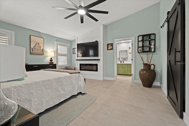 1446 Stone Trl, Enterprise, FL 32725 - bedroom featuring lofted ceiling, a barn door, light tile patterned floors, a sink, and a fireplace
