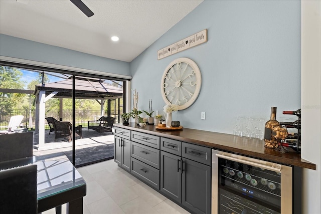 1446 Stone Trl, Enterprise, FL 32725 - bar with beverage cooler, light tile patterned floors, a bar, ceiling fan, and vaulted ceiling
