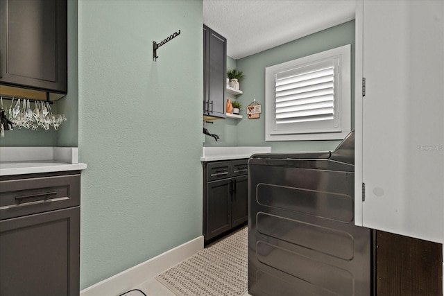 1446 Stone Trl, Enterprise, FL 32725 - clothes washing area featuring baseboards and cabinet space