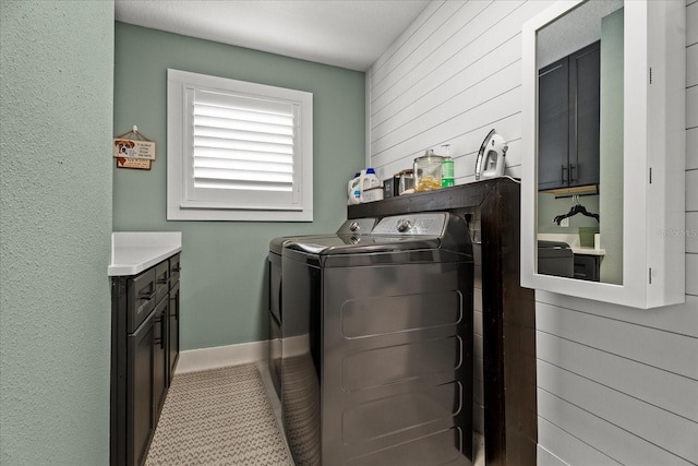1446 Stone Trl, Enterprise, FL 32725 - laundry area featuring baseboards, wooden walls, and independent washer and dryer
