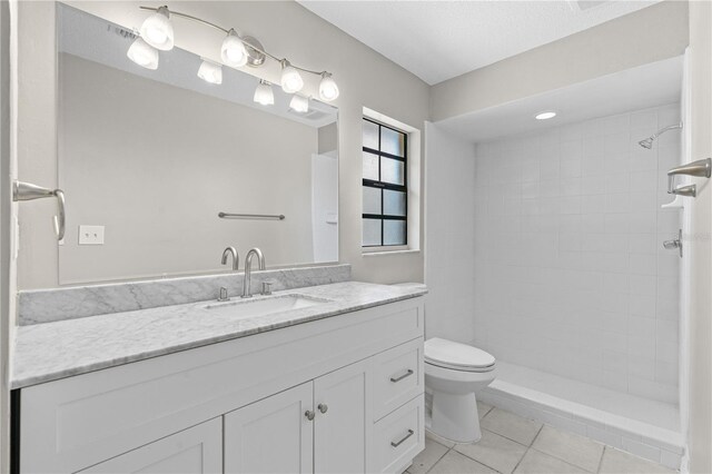 5788 Devon St, Port Orange, FL 32127 - bathroom with tile patterned floors, vanity, toilet, and a tile shower