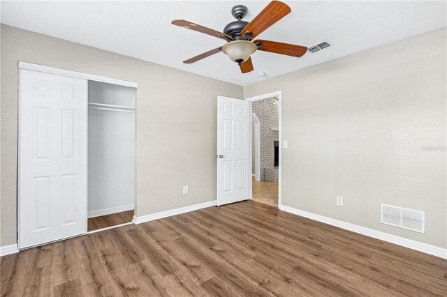 5788 Devon St, Port Orange, FL 32127 - unfurnished bedroom with wood finished floors, baseboards, a closet, and a ceiling fan