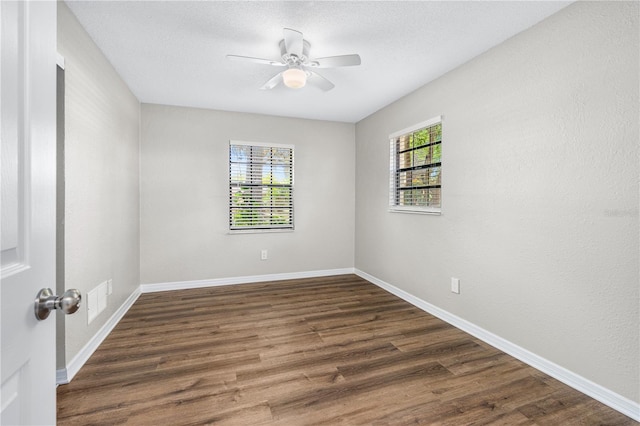 5788 Devon St, Port Orange, FL 32127 - unfurnished room with a ceiling fan, dark wood-style flooring, and baseboards