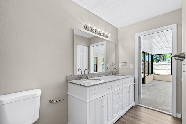 5788 Devon St, Port Orange, FL 32127 - full bath with wood finished floors, toilet, and double vanity